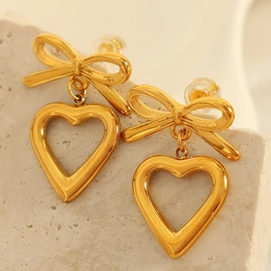 French style gold bow earrings with hollow heart pendants in titanium steel and 18K plating