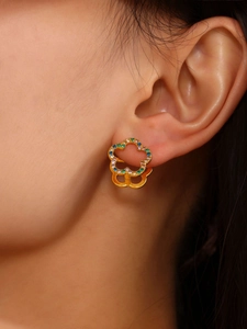 Detailed close-up of 18K gold plated flower hoop earring with colorful zircon on ear