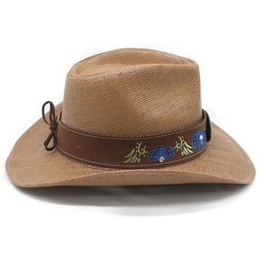 Detail of light brown straw cowboy hat with blue floral embroidery and rhinestone band