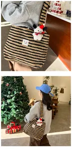 Detail of plush striped tote bag with festive puppy charm and high-quality faux fur texture