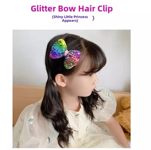 Detail of laser sequins bow hair clip on girl's hair for sparkling princess hairstyle