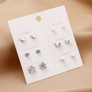 Detail of 6-pair weekly earring set with heart, butterfly and faux pearl designs