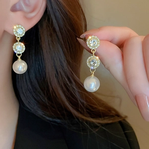 Elegant long drop earrings with white pearls and sparkling crystals on golden hoops