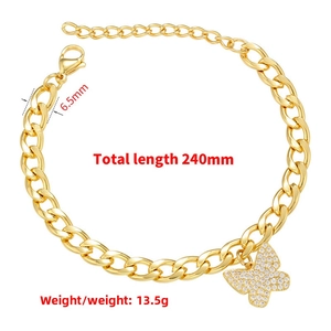 Macro view of gold curb chain link showing 6.5mm width and cubic zirconia butterfly pendant