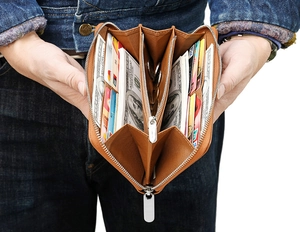 Detail view of the brown leather wallet showing multiple card slots and zipper compartment