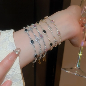 Luxurious layered bracelets with oval pink and black zircon stones in gold and silver finish