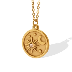 Gold plated celestial necklace with sun and moon pendant featuring a zircon center