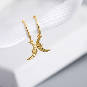 Baroque style S925 sterling silver moon earrings hanging on a white ribbon