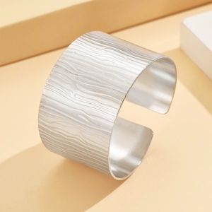 Silver wide cuff bracelet with vintage textured pattern in irregular stainless steel finish