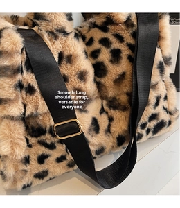 Detail of leopard print plush tote bag featuring an adjustable black shoulder strap and gold hardware