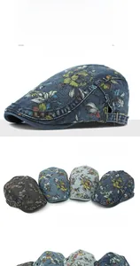 Detail of ethnic floral print on washed denim beret with adjustable side buckle