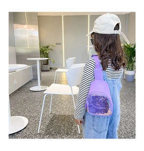 Detail of purple glitter chest bag for kids with transparent PVC window and colorful sequins