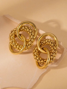 Detail of gold titanium steel hoop earrings with interlinked textured and smooth rings