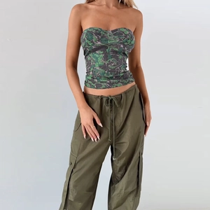 Close-up of camouflage tube top and cargo pants with waist drawstring detail