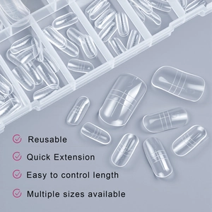 Macro view of clear nail extension molds with scale markings and size numbers