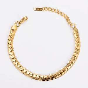 Close-up of 7mm gold plated stainless steel curb chain bracelet with S.STEEL stamp