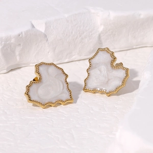 Irregular gold heart stud earrings with white pearl inlay on minimalist stone base
