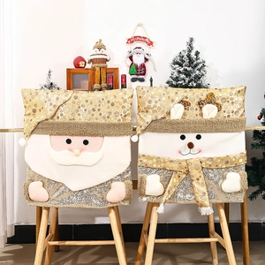 Detail of Santa and Snowman chair covers with champagne gold sequins and 3D plush accents