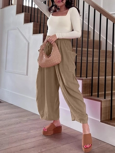 Detailed close-up of khaki cotton-linen wide-leg trousers with cargo side pockets
