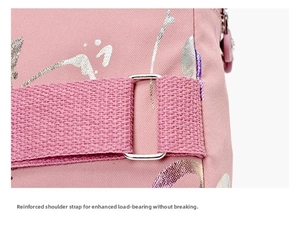 Detail of reinforced stitching and metal adjustment buckle on pink crossbody bag strap