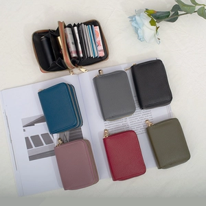 Minimalist accordion card holder with gold zipper and multi-slot leather organization