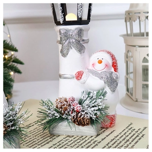 Detail of Christmas snowman street lamp figurine with glitter finish for holiday decor