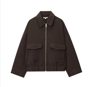 Detail of dark brown zip-up jacket featuring wide collar and large utility pockets