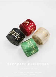 Detail of Christmas ribbons with gold Merry Christmas print in red black and green