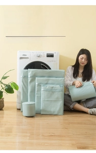 Close-up of fine mesh laundry bag set with protective zippers in a home setting