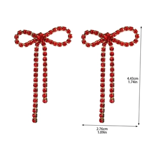 Detailed view of red rhinestone bow tassel earrings with dimensions in inches and cm