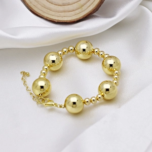 Polished 18k gold plated beaded bracelet featuring large and small spheres with lobster clasp