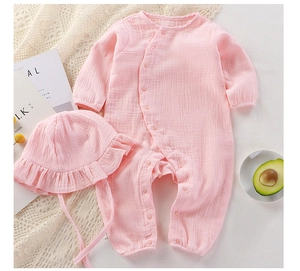 Soft pink cotton gauze baby romper and matching ruffled hat set for newborns and infants