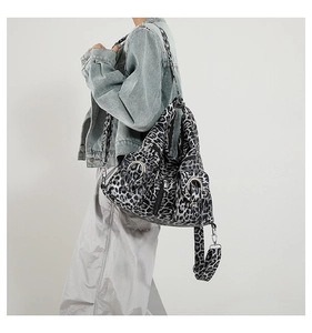 Detail view of large grey leopard print tote bag featuring a metallic ring and side profile