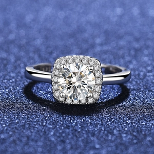 Macro shot of S925 sterling silver ring showing halo-set brilliant-cut zircon on blue background