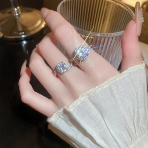 Close-up of double round zircon open ring with pavé diamonds on elegant hand