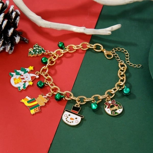 Close-up of Christmas charm bracelet with bell, snowman and reindeer on festive background