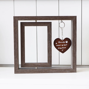 Close-up of a rotating wooden pet memorial frame with a heart tag and memorial text