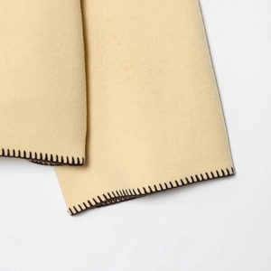 Beige faux wool jacket featuring a high neck and elegant brown contrast stitching detail