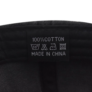 Close-up of the 100% cotton material and washing instructions label inside the baseball cap