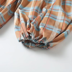 Relaxed orange and blue plaid lantern pants with elastic cuffs and woven texture