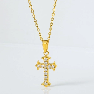 Elegant gold cross pendant necklace featuring micro-pave cubic zirconia on white background