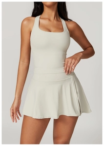 Detail of racerback tank top and side slit skirt in beige quick-dry stretch fabric