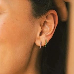 Detailed view of s925 sterling silver hoop earrings with purple and green zircon stones