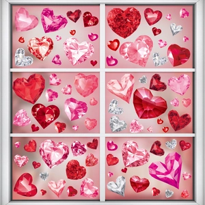 Detailed view of red ruby heart window clings with gemstone texture on a white window frame