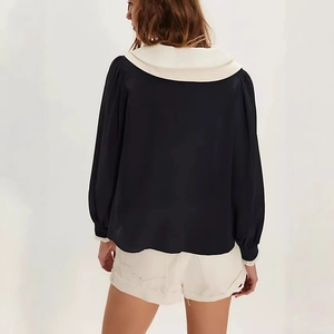 Back view of a French style black chiffon blouse with large white bow collar