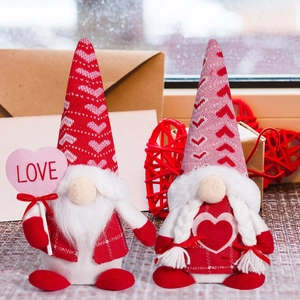 Close-up of Valentine Gnomes dolls with LOVE sign and knitted hearts in a cozy setting