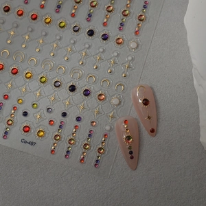 Detail of sun moon and star nail stickers with colorful gems and metallic outlines