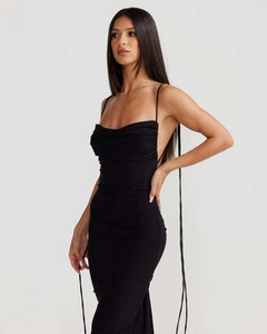 Detail view of backless design with slender tie-up straps on a sleek black maxi dress