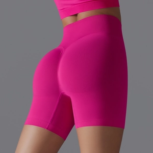Macro detail of high-waist ribbed waistband and seamless rose red yoga shorts fabric