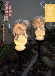 Solar powered angel statue garden light with warm LED glowing orb on a ground stake